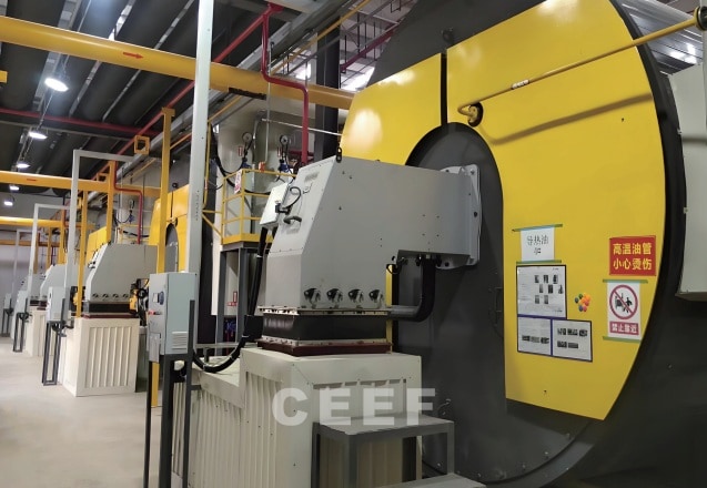 Row of CEEF thermal oil heaters with burners in a Keshun waterproofing factory heater room